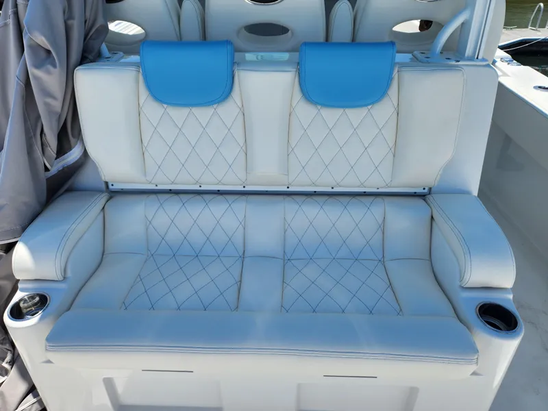 Slide: The Image of Luxurious seating on 2018 HCB 39 Speciale boat with blue accents and cup holders. - 13