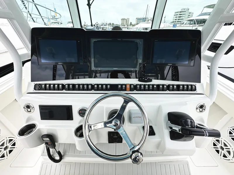 Slide: The Image of Helm of 2018 HCB 39 Speciale boat with advanced navigation controls and steering wheel. - 21