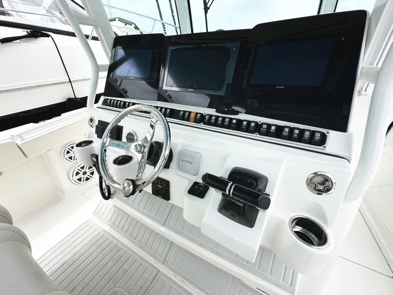 Slide: The Image of 2018 HCB 39 Speciale boat dashboard with steering wheel and multiple display screens. - 22