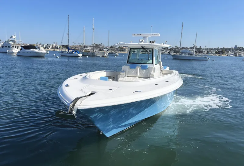 Slide: The Image of 2018 HCB 39 Speciale boat cruising in a marina with clear blue skies. - 3