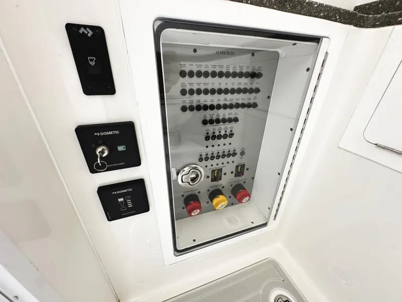 Slide: The Image of Control panel of a 2018 HCB 39 Speciale boat, featuring switches and key access. - 38