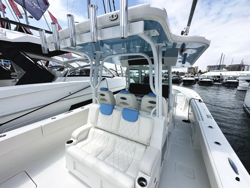 Slide: The Image of 2018 HCB 39 Speciale boat with luxurious seating and sleek design at a marina. - 7