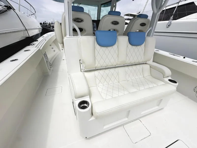 Slide: The Image of 2018 HCB 39 Speciale boat interior with white seating and blue accents. - 9