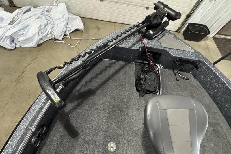 Slide: The Image of 2026 Nitro ZV19 Sport boat interior with Minn Kota trolling motor and gray seating. - 14