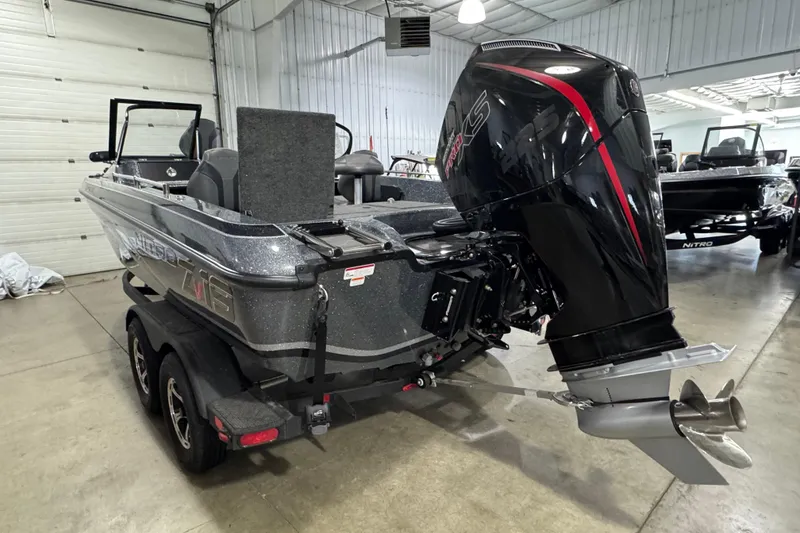 Slide: The Image of 2026 Nitro ZV19 Sport boat with powerful outboard motor in a showroom. - 4