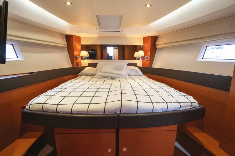 Slide: The Image of Luxurious cabin interior of 2014 Jeanneau NC 14 yacht with cozy bed and modern design. - 32