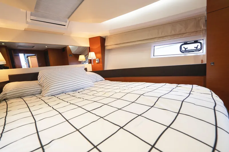 Slide: The Image of Luxurious interior cabin of 2014 Jeanneau NC 14 yacht with modern bedding and lighting. - 34