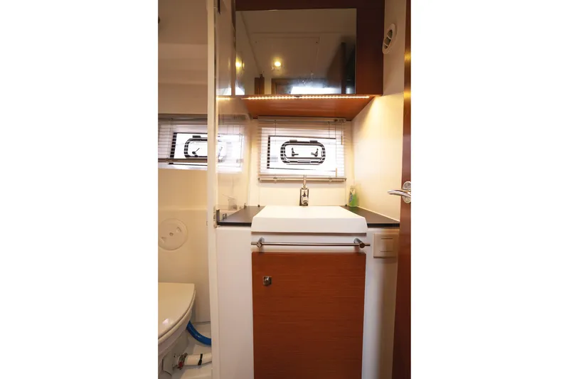 Slide: The Image of 2014 Jeanneau NC 14 yacht bathroom with modern sink and window blinds. - 42