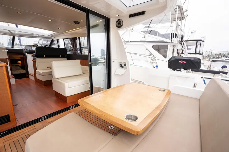 Slide: The Image of Interior view of 2014 Jeanneau NC 14 yacht, featuring seating and dining area. - 7