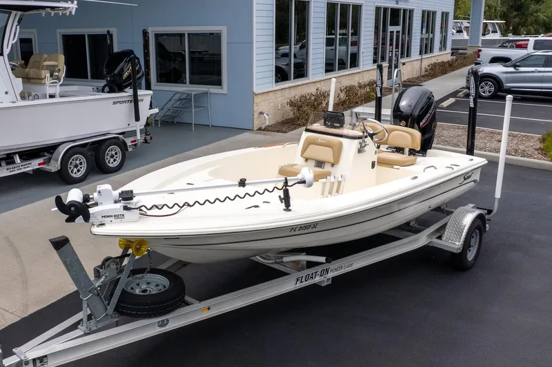 The Image of 2019 Scout 177 Sportfish Flats boat on trailer, parked outside a building. - 0