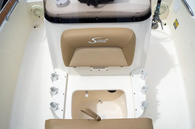 Slide: The Image of 2019 Scout 177 Sportfish Flats boat interior with tan seating and rod holders. - 10