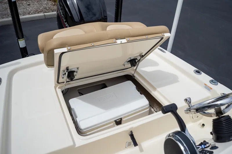 Slide: The Image of 2019 Scout 177 Sportfish Flats boat with open storage compartment and cooler. - 12