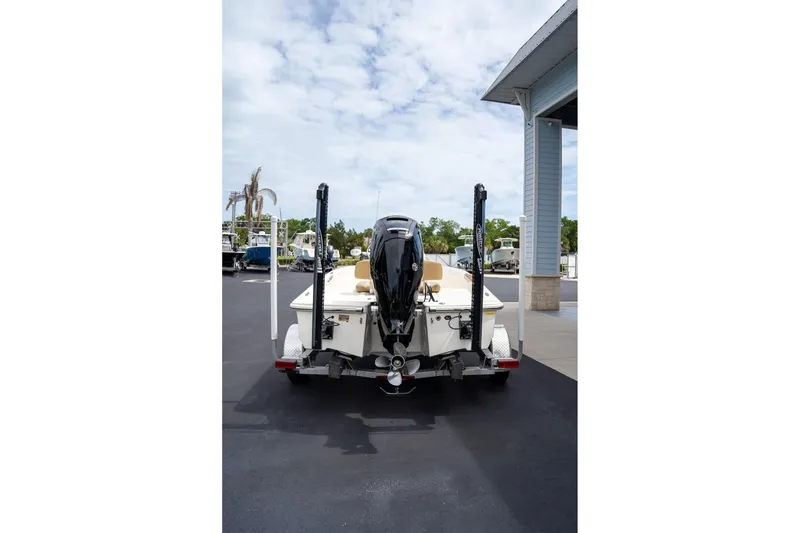 Slide: The Image of 2019 Scout 177 Sportfish Flats boat on trailer, rear view, parked outdoors. - 19
