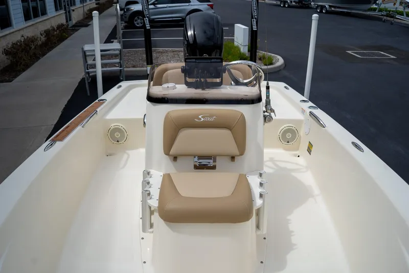 Slide: The Image of 2019 Scout 177 Sportfish Flats boat interior with beige seating and steering console. - 9