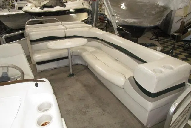 Slide: The Image of 2005 Harris FloteBote Cruiser 240 interior with white seating and table. - 10