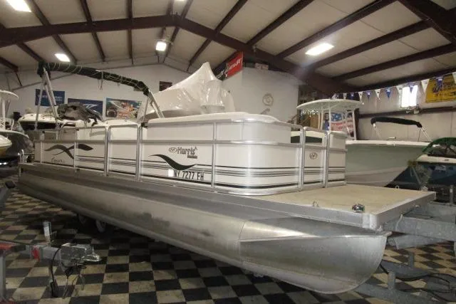 Slide: The Image of 2005 Harris FloteBote Cruiser 240 pontoon boat in indoor showroom. - 2