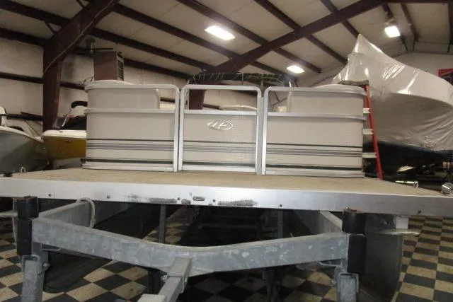 Slide: The Image of 2005 Harris FloteBote Cruiser 240 pontoon boat in indoor storage facility. - 3