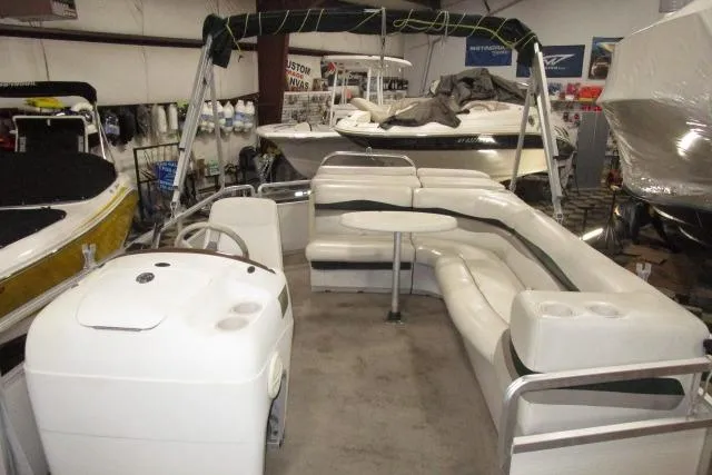 Slide: The Image of 2005 Harris FloteBote Cruiser 240 pontoon boat with spacious seating and helm in a showroom. - 5