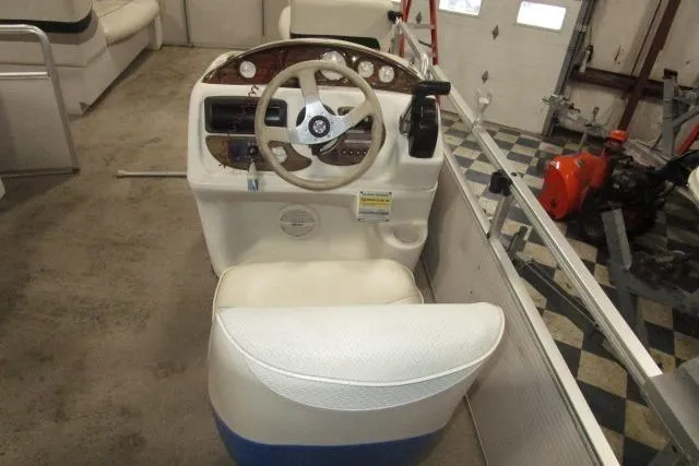 Slide: The Image of 2005 Harris FloteBote Cruiser 240 helm with steering wheel and control panel. - 6