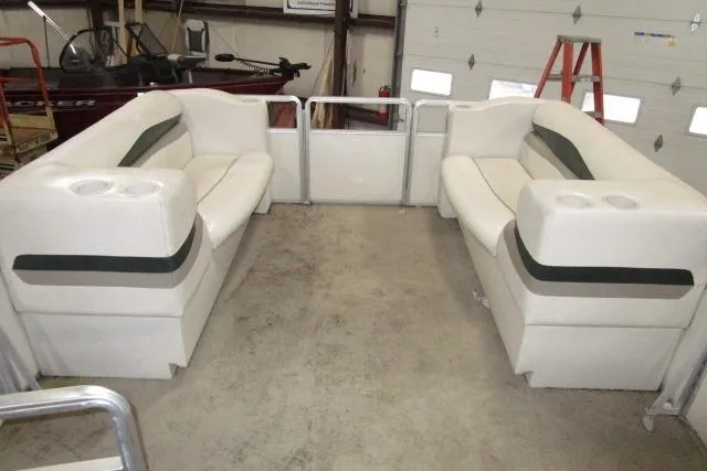 Slide: The Image of 2005 Harris FloteBote Cruiser 240 interior with white seating and cup holders. - 8