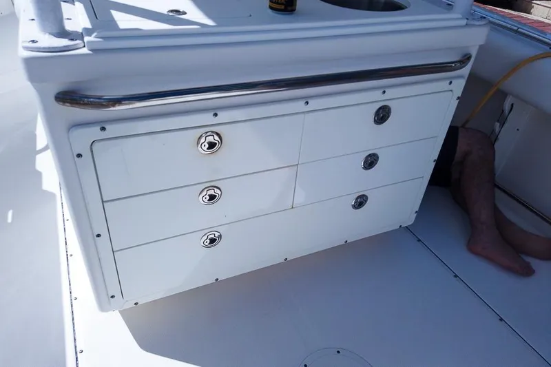 Slide: The Image of 2015 Edgewater 320CC boat interior with storage drawers and sink. - 10