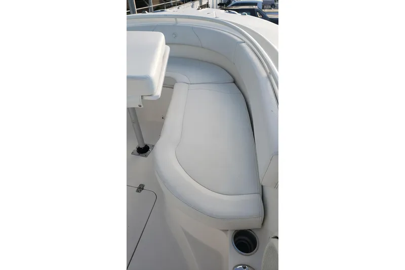 Slide: The Image of 2015 Edgewater 320CC boat interior with white cushioned seating. - 11
