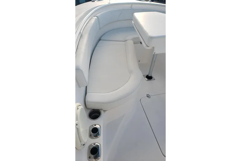 Slide: The Image of 2015 Edgewater 320CC boat interior with white seating and cup holders. - 12