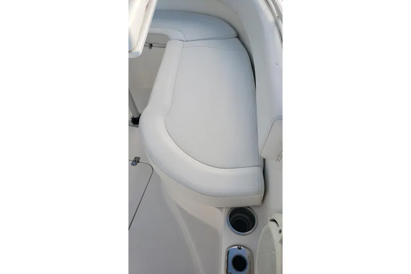 Slide: The Image of White cushioned seating on a 2015 Edgewater 320CC boat with cup holders. - 15