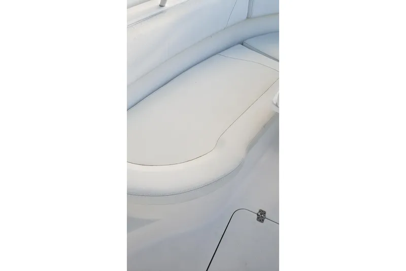 Slide: The Image of Edgewater 320CC 2015 boat interior with white cushioned seating. - 16