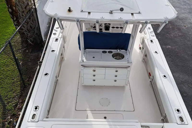 Slide: The Image of 2015 Edgewater 320CC boat interior, featuring spacious deck and center console. - 5