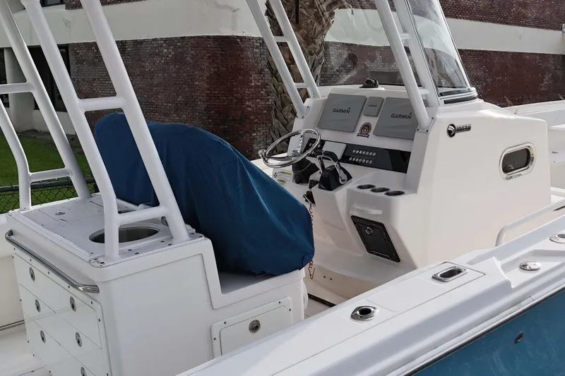 Slide: The Image of 2015 Edgewater 320CC boat cockpit with Garmin navigation system and covered seating. - 6