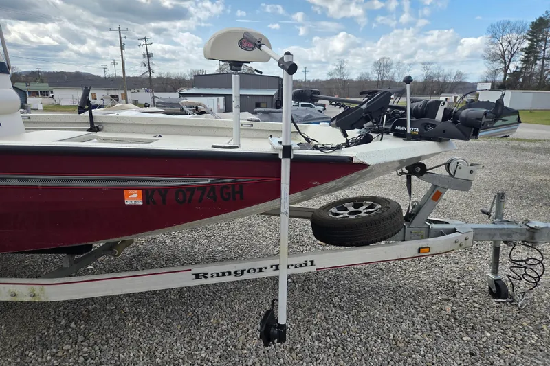 Slide: The Image of 2017 Ranger RB190 Bay boat on trailer, parked on gravel lot under cloudy sky. - 5