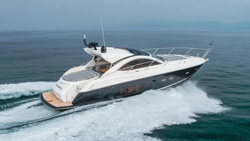 Slide: The Image of 2012 Sunseeker Portofino 48 yacht cruising on open water. - 1
