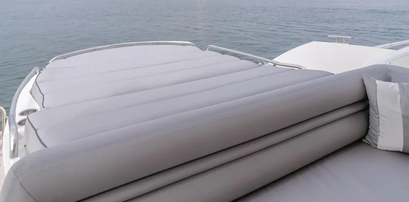 Slide: The Image of Sunseeker Portofino 48 yacht's sunbed area, 2012 model, overlooking calm ocean waters. - 10