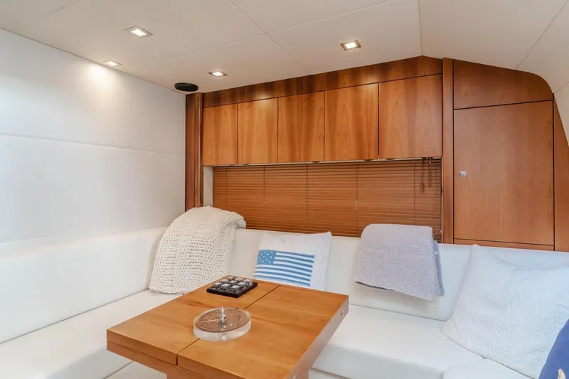 Slide: The Image of Luxurious interior of 2012 Sunseeker Portofino 48 yacht with cozy seating and wooden accents. - 13
