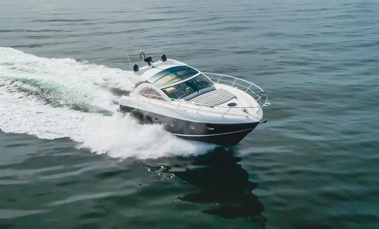 Slide: The Image of 2012 Sunseeker Portofino 48 yacht cruising on open water. - 2