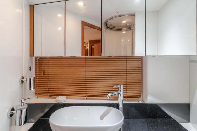 Slide: The Image of Luxurious bathroom in 2012 Sunseeker Portofino 48 yacht with modern sink and wooden blinds. - 20