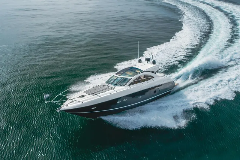 Slide: The Image of 2012 Sunseeker Portofino 48 yacht cruising on open water, creating a dynamic wake. - 3
