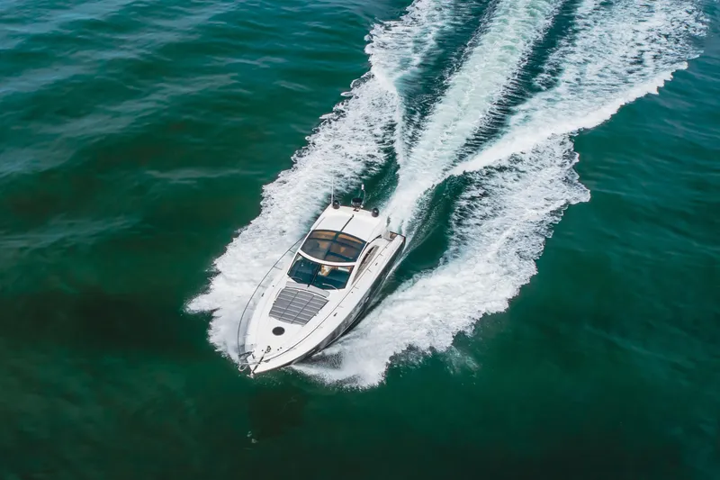 Slide: The Image of 2012 Sunseeker Portofino 48 yacht cruising on open water, aerial view. - 4