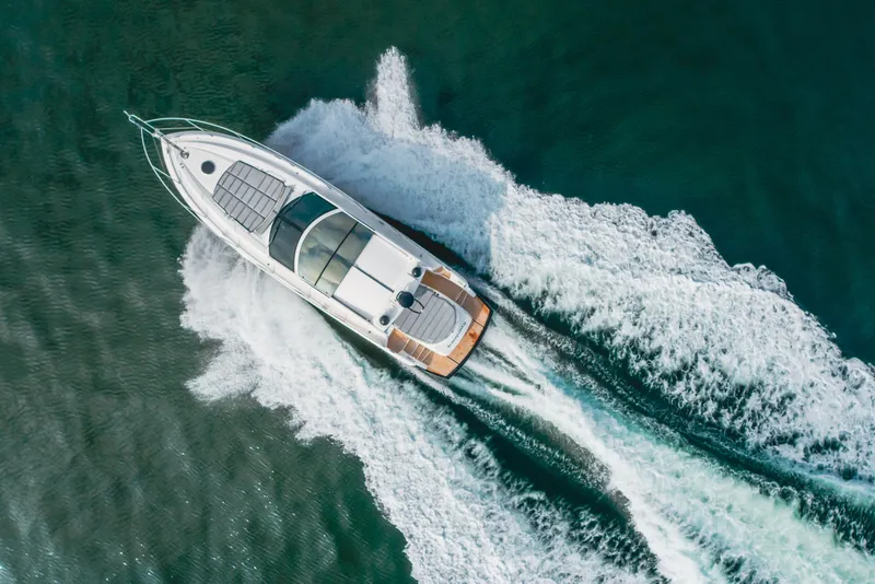 Slide: The Image of Aerial view of 2012 Sunseeker Portofino 48 yacht cruising on open water. - 5