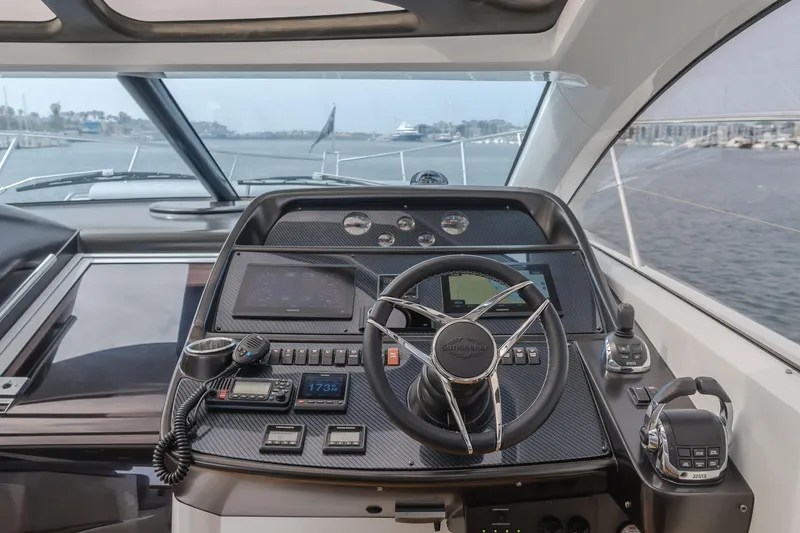 Slide: The Image of Cockpit view of 2012 Sunseeker Portofino 48 yacht with steering wheel and navigation controls. - 7