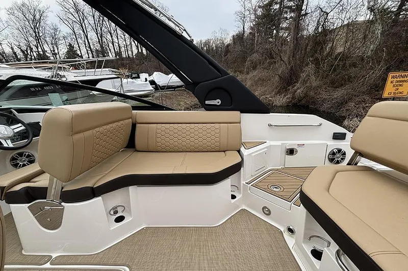 Slide: The Image of 2024 Sea Ray SDX 250 boat interior with beige seating and modern design. - 13
