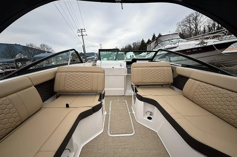 Slide: The Image of 2024 Sea Ray SDX 250 boat interior with beige seating and modern design. - 14
