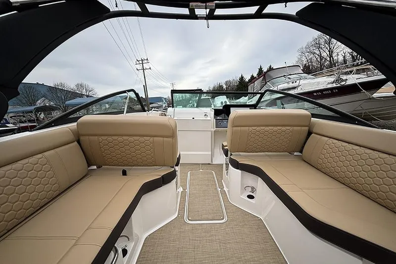 Slide: The Image of 2024 Sea Ray SDX 250 boat interior with beige seating and modern design. - 16