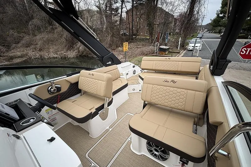 Slide: The Image of 2024 Sea Ray SDX 250 boat interior with beige seating and modern design. - 17