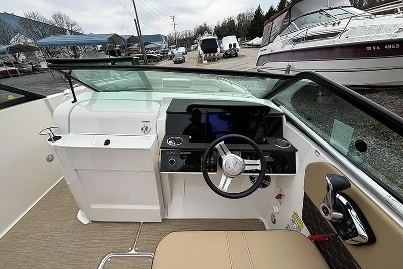 Slide: The Image of 2024 Sea Ray SDX 250 boat cockpit with steering wheel and control panel. - 21