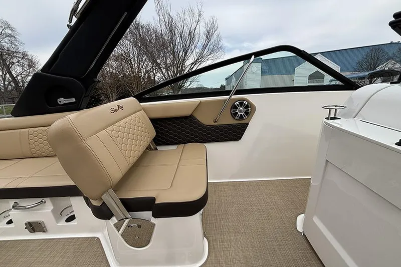 Slide: The Image of 2024 Sea Ray SDX 250 boat interior with beige seating and modern design. - 22