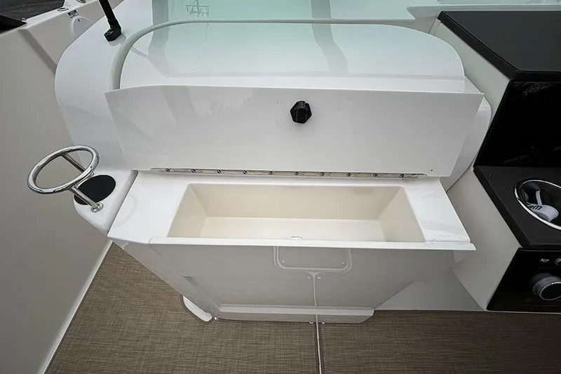 Slide: The Image of 2024 Sea Ray SDX 250 boat sink and storage area with cup holder. - 23