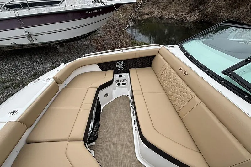 Slide: The Image of 2024 Sea Ray SDX 250 boat interior with tan seating and cup holders. - 28