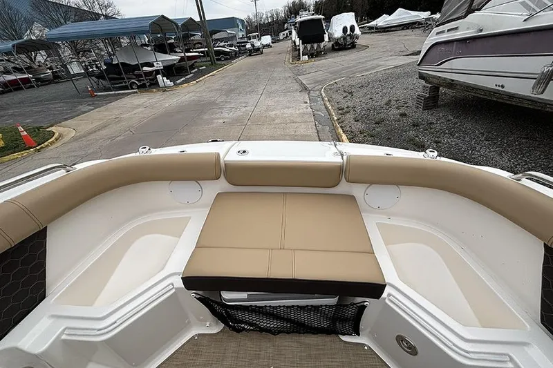 Slide: The Image of 2024 Sea Ray SDX 250 boat interior with beige seating, docked at a marina. - 31